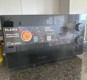 a microwave oven with a cup of coffee in it at Music and Words in Oeiras