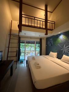 a bedroom with a bunk bed with a ladder at Stellars Samed Resort in Ko Samed +40 photos