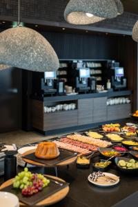 a buffet with different types of food on a table at ARCOTEL Tabakfabrik Linz in Linz