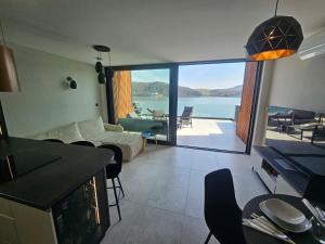 a living room with a view of the water at Rakoczówka in Znamirowice