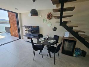 a dining room with a table and chairs and a staircase at Rakoczówka in Znamirowice