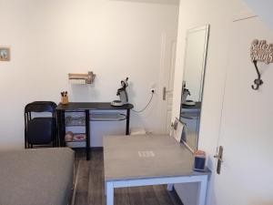 a small room with a table and a mirror at Le Relais de Jeanne in Orbigny