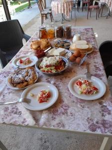 a table with plates of food on a table at Villa Karolina in Ohrid