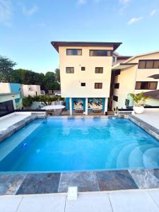 a swimming pool in front of a building at Ocean Winds Hotel in San Felipe de Puerto Plata