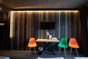 a room with three chairs and a table with a television at Loft & SPA resort ROOMs in Palyanytsya