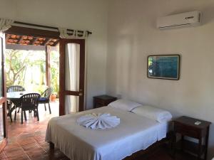 a bedroom with a bed and a table with chairs at Habitacion Mar in Puerto Escondido