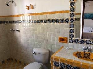 a bathroom with a toilet and a sink at Habitacion Mar in Puerto Escondido +9 photos