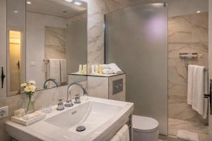 a bathroom with a sink and a mirror at La Bastide Du Port - Hôtel de Charme in Saint-Tropez +24 photos