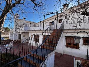 a white house with a staircase in front of it at cerronegro con terraza in Capileira