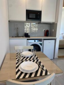 a kitchen with a table with two plates on it at Panoramic View Boutique Suite in Rethymno +5 photos