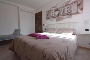 a bedroom with a bed with purple towels on it at Casa Verena in Aosta