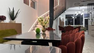 a dining room with a table and red chairs at NOAH ponton in Orşova