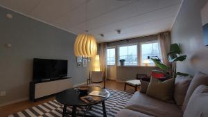a living room with a couch and a tv at 2 Bedroom apartment close to Branäs Resort - Likemovägen 12B in Likenäs