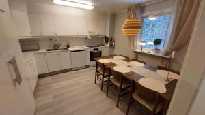 a kitchen with a table and chairs in a room at 2 Bedroom apartment close to Branäs Resort - Likemovägen 12B in Likenäs +28 photos