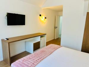 a bedroom with a bed and a tv on the wall at NOAH ponton in Orşova
