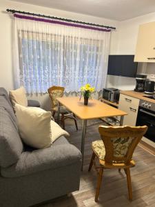 a living room with a couch and a table at Bergblick in Saupsdorf +8 photos