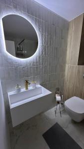 a bathroom with a sink and a toilet and a mirror at NOAH ponton in Orşova +35 photos