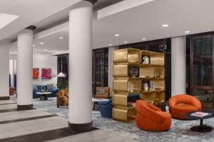 a lobby with columns and a pile of suitcases at The Westshore Grand, Tampa, A Tribute Portfolio Hotel in Tampa