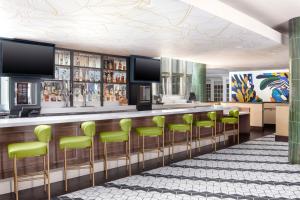 a rendering of a bar with green stools at The Westshore Grand, Tampa, A Tribute Portfolio Hotel in Tampa