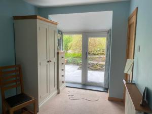 a hallway with a door leading to a patio at Garth Engan B&B with private lounge in Llanbedr