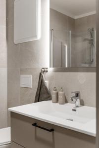 a bathroom with a white sink and a mirror at Motoppen, Høgeggvegen 4B in Trysil