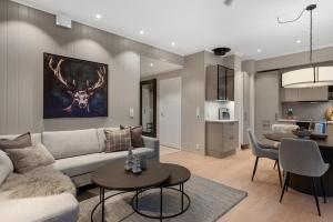 a living room with a couch and a table at Motoppen, Høgeggvegen 4B in Trysil +12 photos
