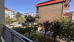 a balcony of a building with trees and buildings at Mitxelena in Zarautz