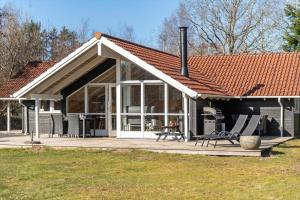 a house with a large deck with a roof at VE508-Oksbol-Blomstervangen-123 in Oksbøl
