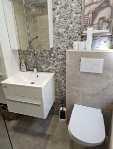 a bathroom with a white sink and a toilet at Sea Paradise Piran in Piran