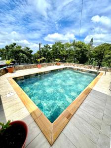 a swimming pool with blue water in the middle at Ti Caz Bana in Le Tampon