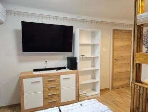 a living room with a flat screen tv on a wall at Sea Paradise Piran in Piran