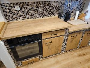 a kitchen with a wooden counter top and a microwave at Sea Paradise Piran in Piran +16 photos