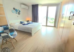a bedroom with a bed and a table and a window at Studio Evian in Paleo Tsifliki