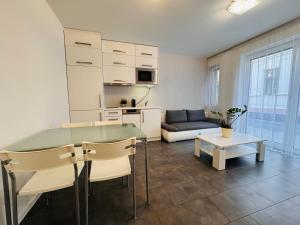 a living room with a table and a couch at Central Seven Apartman - Free Parking in Győr
