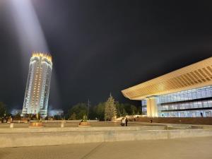 a building with lights on top of it at night at Corps-A in Almaty