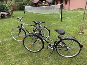 two bikes parked in the grass next to a goal at Familienurlaub am See - Haus nr 1 - Rokitki in Rokitki