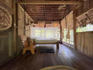 a bedroom with a bed and a chair in a room at CHUNAKI ECOLODGES - Authentic Activities and Food in the Amazon in Zaragoza +23 photos
