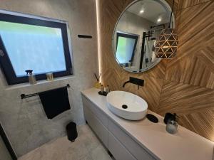 a bathroom with a white sink and a mirror at Rakoczówka in Znamirowice +11 photos