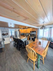 a large kitchen with a wooden table and chairs at The Saco Valley Stay in Conway