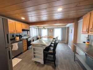 a kitchen with a island in a tiny house at The Saco Valley Stay in Conway +7 photos