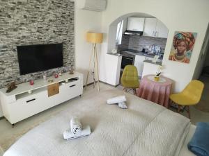 a living room with a large bed and a tv at Apt Amor in Bihać