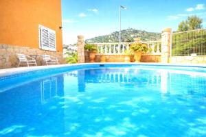 a large blue swimming pool in a yard at VIP private Poolsuite Calafell in Calafell