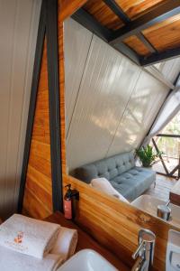 a bathroom with a sink and a couch in a house at Shambhala Holistic Resort Only Adults in Manzanillo