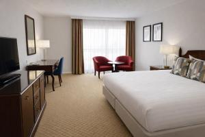 a hotel room with a large bed and a television at The Aberdeen Dyce Hotel in Dyce