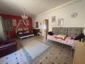 a living room with a couch and a table at Bastide de Valvérane in Manosque +17 photos