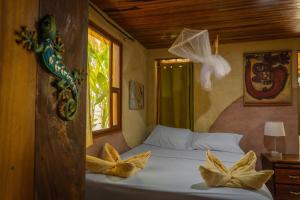 a bedroom with a bed with two pillows on it at Montezuma Heights in Montezuma