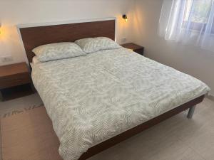 a bed in a bedroom with two pillows on it at Pag House in Pag