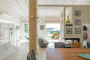 a living room with a table and a fireplace at Villa dei Gruccioni - YourPlace Abruzzo in Torino di Sangro