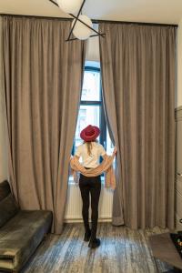 a woman is standing in front of a window at Olympic Boutique in Constanţa