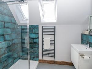 a bathroom with a glass shower and a sink at Valley View Hideaway in Llandysul +24 photos